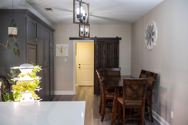 305 Shepherd Ln, Royse City, TX 75189 - dining space featuring dark wood-type flooring, a chandelier, and a barn door