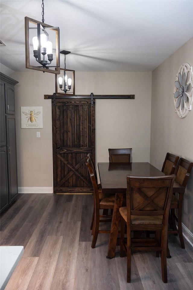 305 Shepherd Ln, Royse City, TX 75189 - dining space featuring a barn door, dark wood finished floors, and a chandelier