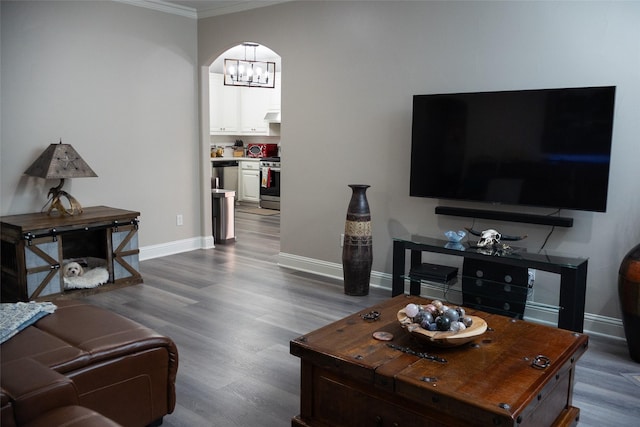 305 Shepherd Ln, Royse City, TX 75189 - living area with crown molding, dark wood-style floors, a chandelier, and arched walkways