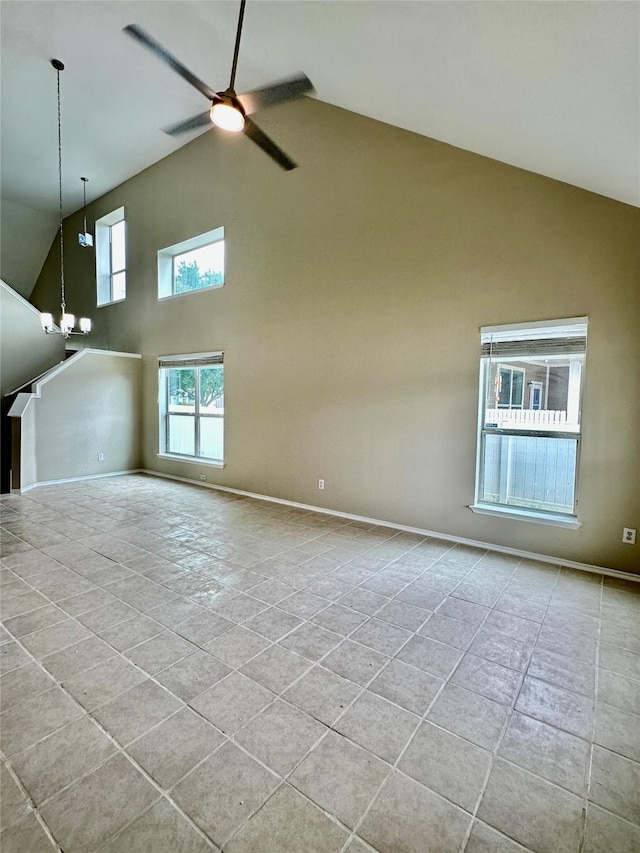 1736 Goodwin Dr, Providence Village, TX 76227 - unfurnished living room featuring high vaulted ceiling, ceiling fan, a chandelier, and tile patterned floors