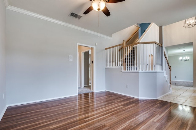 1403 Bosher Dr, Cedar Hill, TX 75104 - empty room with a chandelier, wood finished floors, ceiling fan, stairway, and ornamental molding