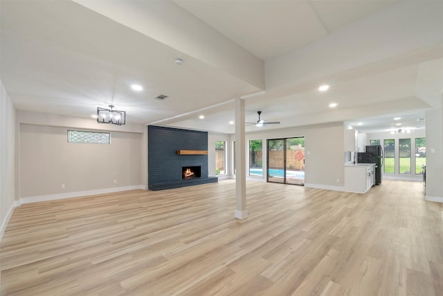809 Havenwood Ln S, Fort Worth, TX 76112 - unfurnished living room featuring a brick fireplace, plenty of natural light, recessed lighting, light wood-style floors, and a ceiling fan