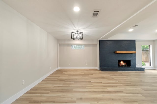 809 Havenwood Ln S, Fort Worth, TX 76112 - unfurnished living room with plenty of natural light, a fireplace, light wood-style flooring, recessed lighting, and a chandelier
