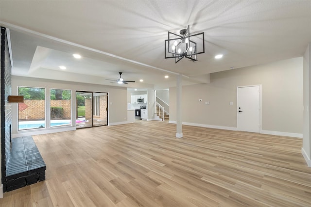 809 Havenwood Ln S, Fort Worth, TX 76112 - unfurnished living room with stairs, light wood-style flooring, recessed lighting, a ceiling fan, and a chandelier