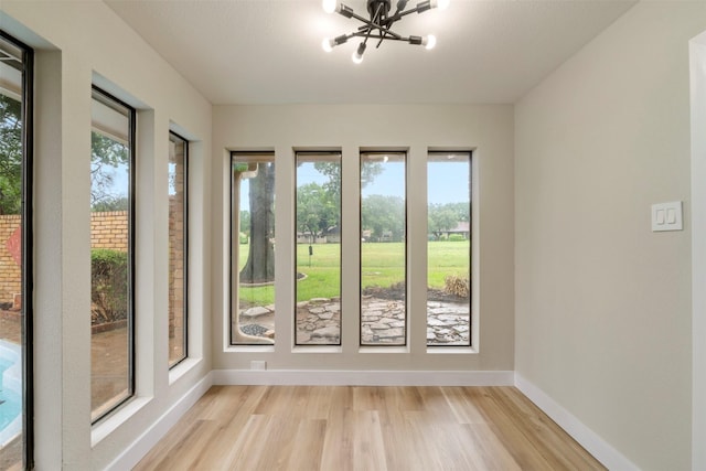 809 Havenwood Ln S, Fort Worth, TX 76112 - unfurnished sunroom with wood finished floors and a chandelier