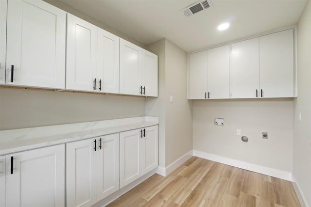 809 Havenwood Ln S, Fort Worth, TX 76112 - washroom featuring cabinet space, electric dryer hookup, light wood-style flooring, washer hookup, and recessed lighting