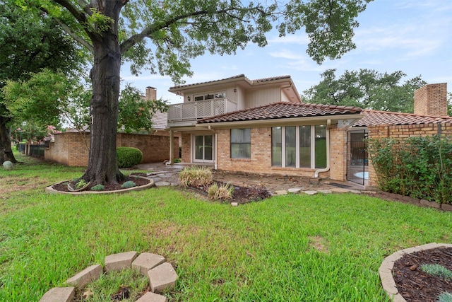 809 Havenwood Ln S, Fort Worth, TX 76112 - back of house featuring a tiled roof, a balcony, a patio, and brick siding