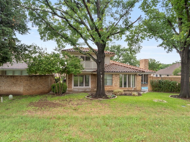 809 Havenwood Ln S, Fort Worth, TX 76112 - rear view of house with a tile roof, a chimney, and brick siding