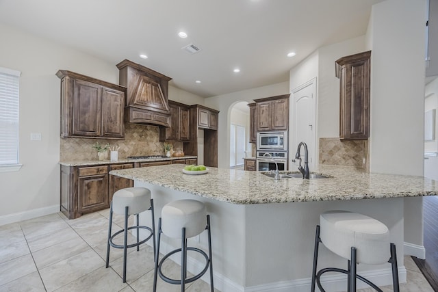 6913 Chisholm Trl, North Richland Hills, TX 76182 - kitchen with stainless steel appliances, a peninsula, light stone countertops, tasteful backsplash, and recessed lighting