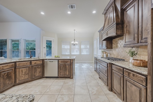 6913 Chisholm Trl, North Richland Hills, TX 76182 - kitchen with stainless steel appliances, decorative backsplash, a chandelier, healthy amount of natural light, and recessed lighting