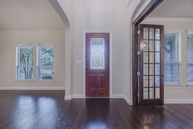 6913 Chisholm Trl, North Richland Hills, TX 76182 - foyer entrance with arched walkways, wood finished floors, and crown molding