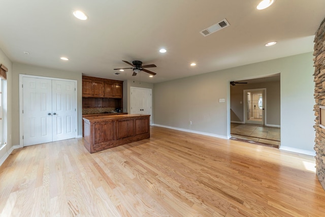 1022 Kings Row, Denton, TX 76209 - unfurnished living room featuring a ceiling fan, recessed lighting, and light wood-type flooring