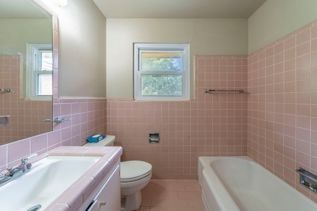 1022 Kings Row, Denton, TX 76209 - full bathroom featuring tile walls, healthy amount of natural light, tile patterned flooring, a bath, and vanity