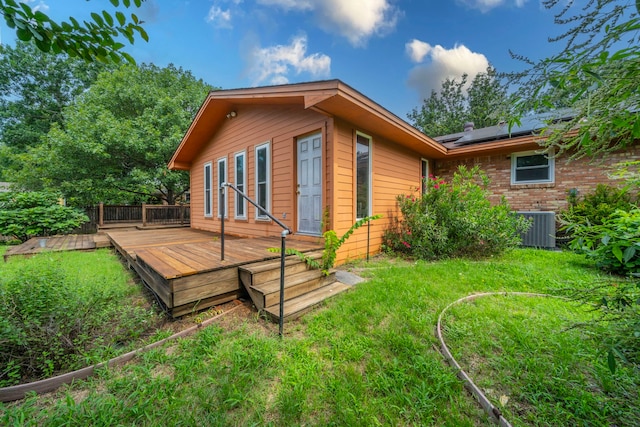 1022 Kings Row, Denton, TX 76209 - rear view of property featuring solar panels, a deck, and a yard