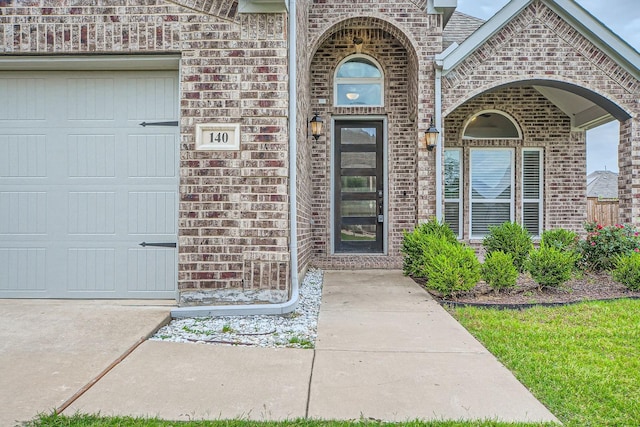 140 Godstone Ln, Prosper, TX 75078 - view of exterior entry featuring brick siding and a garage