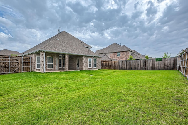 140 Godstone Ln, Prosper, TX 75078 - back of house featuring a fenced backyard, brick siding, roof with shingles, and a patio