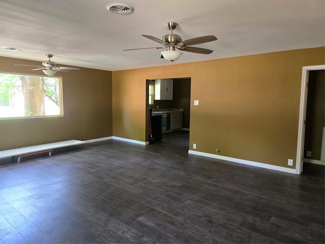 818 N Commerce St, Gainesville, TX 76240 - spare room featuring a ceiling fan and dark wood finished floors