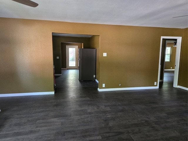 818 N Commerce St, Gainesville, TX 76240 - spare room featuring ceiling fan, plenty of natural light, and dark wood-style flooring