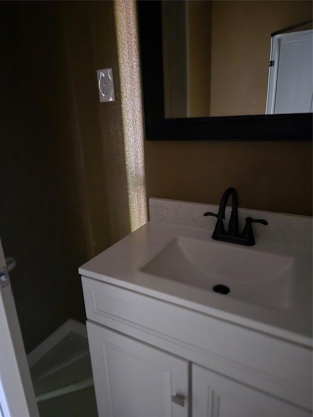 818 N Commerce St, Gainesville, TX 76240 - bathroom with vanity and a textured wall