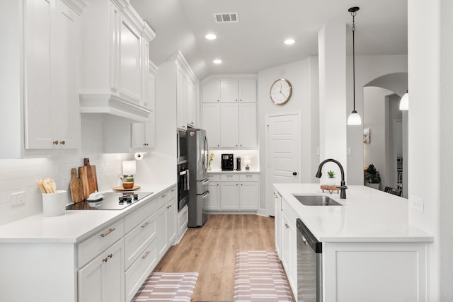 458 Red Maple Rd, Waxahachie, TX 75165 - kitchen featuring electric stovetop, stainless steel dishwasher, arched walkways, decorative backsplash, and white cabinets