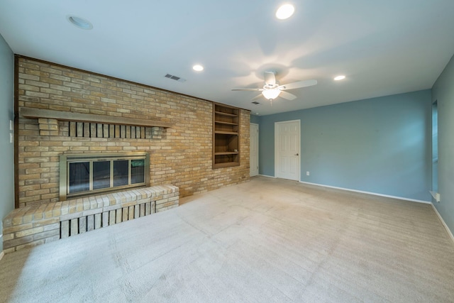 4524 Coyote Pt, Denton, TX 76208 - unfurnished living room featuring built in shelves, ceiling fan, a fireplace, carpet floors, and recessed lighting