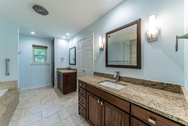 4524 Coyote Pt, Denton, TX 76208 - bathroom with two vanities, tiled bath, tile patterned flooring, and recessed lighting