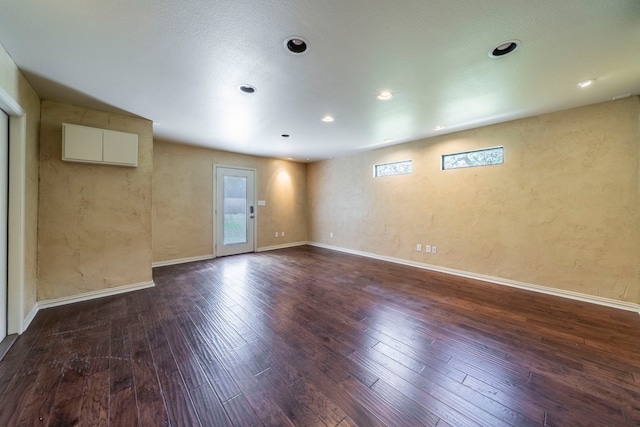 4524 Coyote Pt, Denton, TX 76208 - empty room featuring dark wood-style floors, recessed lighting, and a textured wall