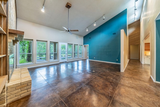 4524 Coyote Pt, Denton, TX 76208 - unfurnished living room featuring rail lighting, high vaulted ceiling, a ceiling fan, and concrete floors