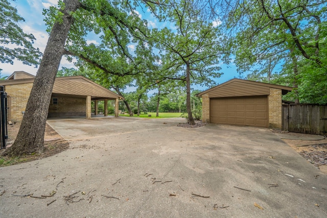 4524 Coyote Pt, Denton, TX 76208 - detached garage featuring concrete driveway and a carport
