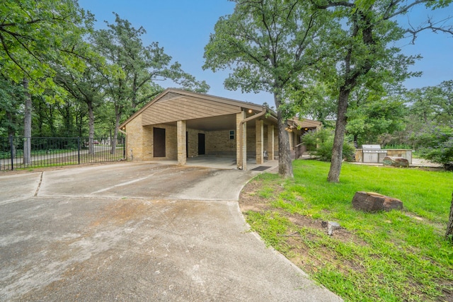 4524 Coyote Pt, Denton, TX 76208 - view of front of home featuring concrete driveway, brick siding, and a carport
