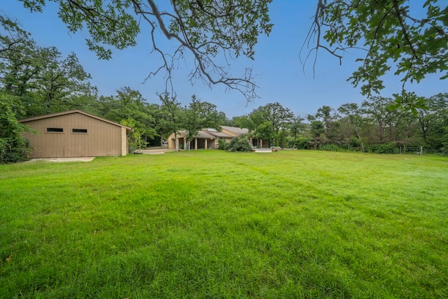 4524 Coyote Pt, Denton, TX 76208 - view of green lawn with a garage and an outdoor structure