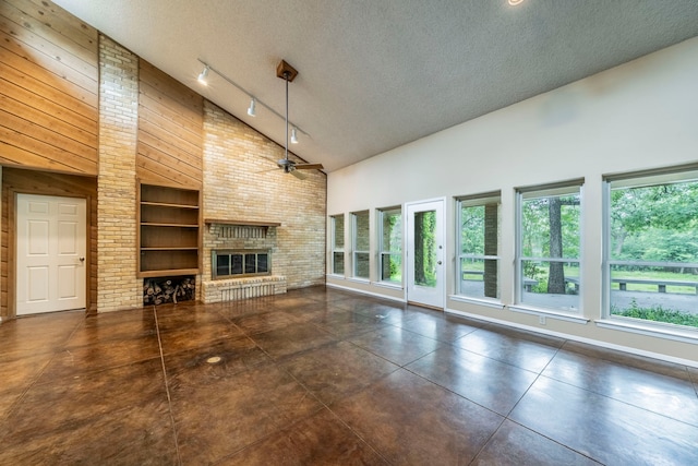 4524 Coyote Pt, Denton, TX 76208 - unfurnished living room featuring high vaulted ceiling, plenty of natural light, a brick fireplace, a textured ceiling, and ceiling fan