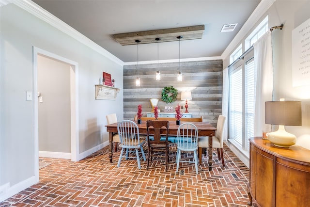 200 Stone Hollow Ct, Prosper, TX 75078 - dining space with wood walls, brick floors, ornamental molding, and an accent wall
