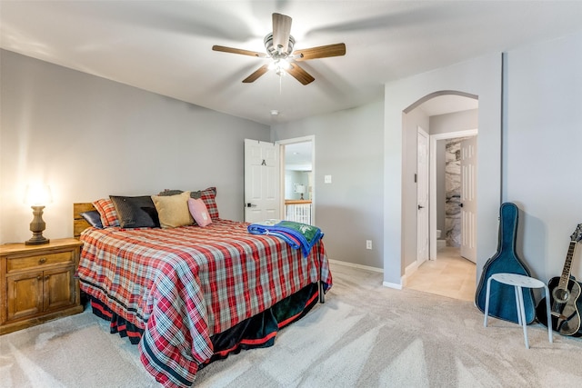 200 Stone Hollow Ct, Prosper, TX 75078 - bedroom featuring arched walkways, light carpet, a ceiling fan, and ensuite bathroom