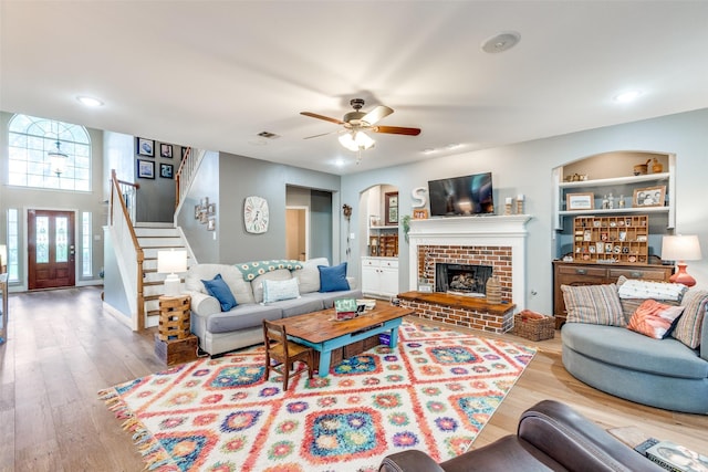 200 Stone Hollow Ct, Prosper, TX 75078 - living room with wood finished floors, a ceiling fan, stairway, arched walkways, and recessed lighting