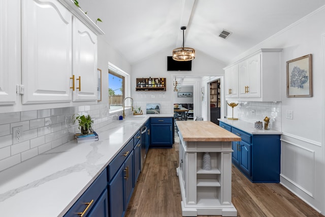 2301 Coleshire Dr, Plano, TX 75075 - kitchen with blue cabinets, open shelves, butcher block counters, white cabinets, and vaulted ceiling