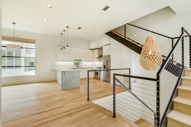 1847 Summit Ave Unit 2B, Dallas, TX 75206 - staircase featuring wood finished floors, a chandelier, and recessed lighting