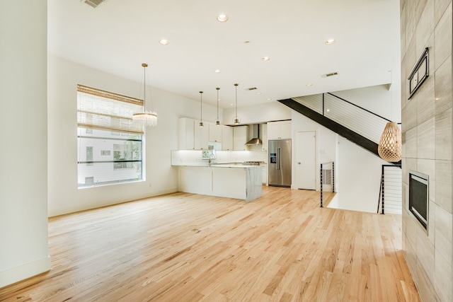 1847 Summit Ave Unit 2B, Dallas, TX 75206 - unfurnished living room with light wood finished floors, recessed lighting, and a tile fireplace