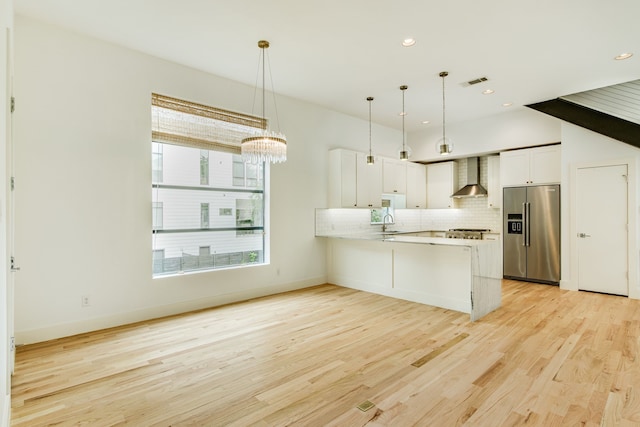 1847 Summit Ave Unit 2B, Dallas, TX 75206 - kitchen featuring high end fridge, wall chimney range hood, backsplash, light wood-style floors, and a peninsula