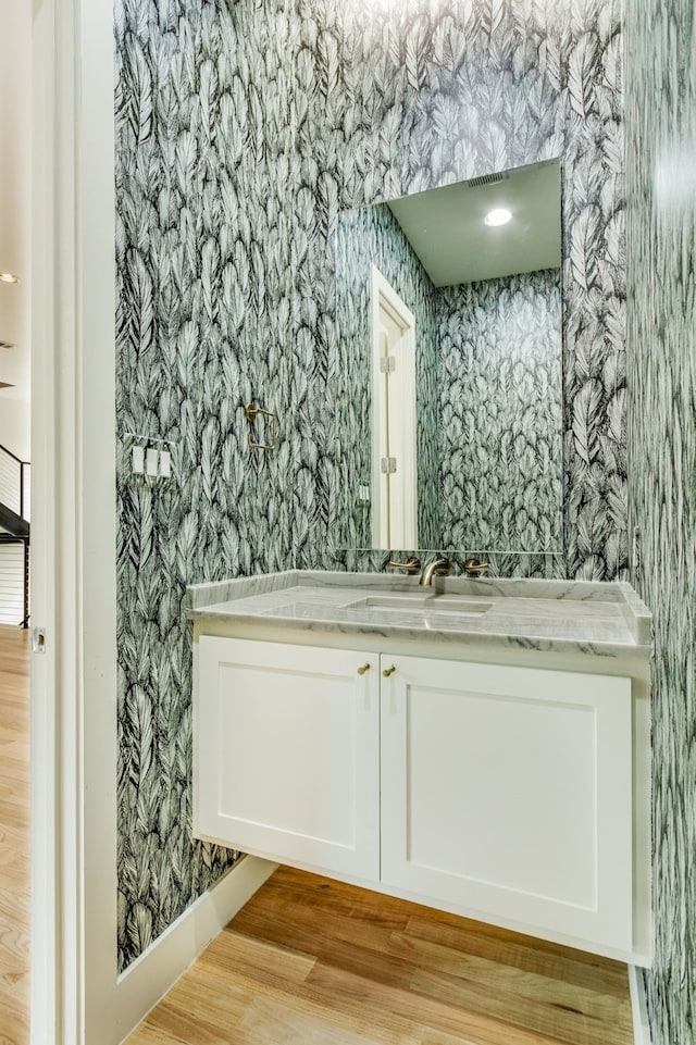 1847 Summit Ave Unit 2B, Dallas, TX 75206 - bathroom with wallpapered walls, vanity, and wood finished floors