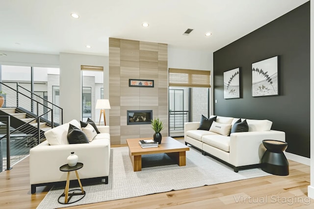 1847 Summit Ave Unit 2B, Dallas, TX 75206 - living room with light wood finished floors, stairway, recessed lighting, and a large fireplace