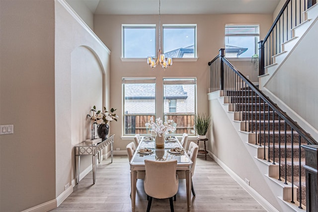 2150 Bristlegrass Rd, Frisco, TX 75033 - dining area featuring a chandelier, stairway, wood finished floors, and a high ceiling