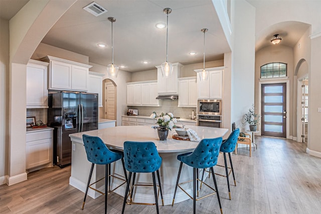 2150 Bristlegrass Rd, Frisco, TX 75033 - kitchen featuring black fridge with ice dispenser, stainless steel oven, built in microwave, backsplash, and recessed lighting