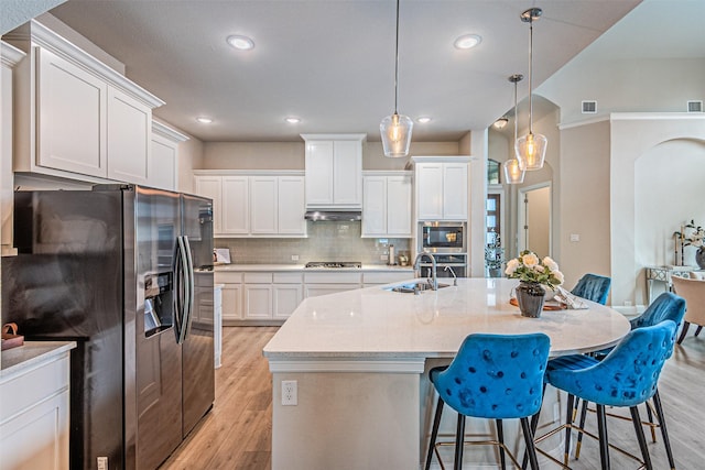 2150 Bristlegrass Rd, Frisco, TX 75033 - kitchen featuring appliances with stainless steel finishes, light wood-style floors, a kitchen breakfast bar, white cabinets, and tasteful backsplash