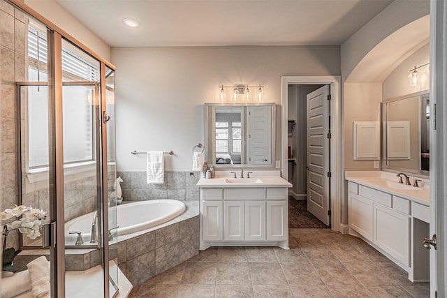 2150 Bristlegrass Rd, Frisco, TX 75033 - bathroom with plenty of natural light, a garden tub, two vanities, and a stall shower