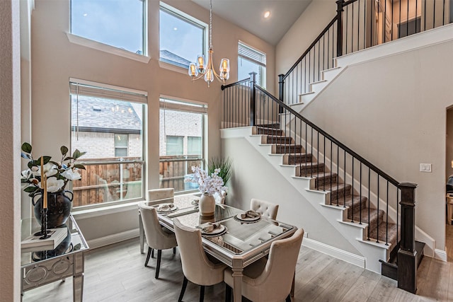 2150 Bristlegrass Rd, Frisco, TX 75033 - dining room with stairs, wood finished floors, healthy amount of natural light, a high ceiling, and recessed lighting