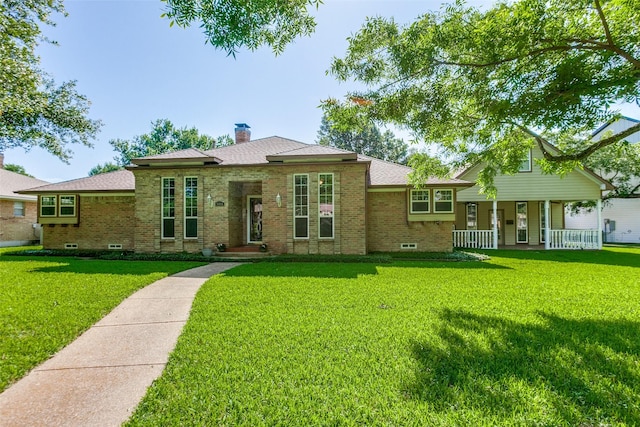5008 Natchez Dr, Sachse, TX 75048 - view of front of home featuring brick siding, a front lawn, a chimney, and covered porch
