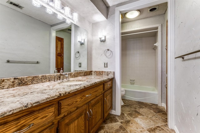 5008 Natchez Dr, Sachse, TX 75048 - bathroom with vanity, washtub / shower combination, and stone finish flooring