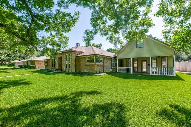 5008 Natchez Dr, Sachse, TX 75048 - rear view of property with covered porch, brick siding, and a chimney