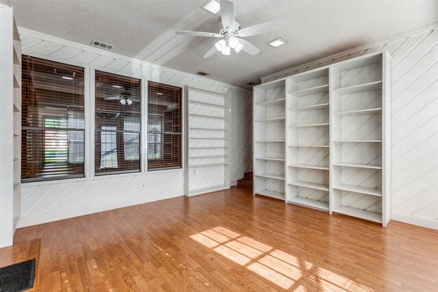 5008 Natchez Dr, Sachse, TX 75048 - spare room featuring a ceiling fan, a textured ceiling, wood finished floors, and wood walls